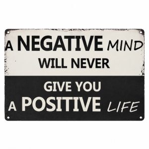 Black and cream wall sign reading “A negative mind will never give you a positive life.”