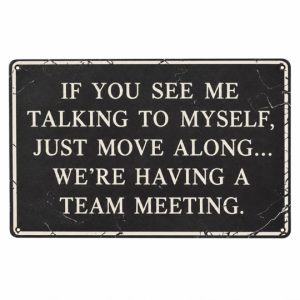 Funny team meeting sign with cream lettering reading If you see me talking to myself, just move along, we’re having a team meeting.